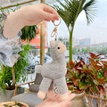 Close-up of grey plush alpaca keychain with gold metal clasp held in hand for size - Gold Clasp / 18cm / Gray