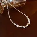 Baroque pearl necklace with champagne beads and gold accents on leather background - Irregular Shell Crystal Necklace