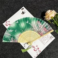 Classic green silk folding fan with plum blossoms, butterflies and matching tassel - Butterflies Flying Green - Light Handle