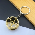 Detailed macro view of a golden 5-spoke car wheel rim keychain made of polished alloy - 5-Spoke Wheel Rim / Gold