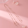 Detailed close-up of rose gold beaded eyewear chain with adjustable silicone loops - Style 02 / Rose Gold