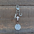 Silver saddle charm clip with feather and horseshoe pendants on rustic wood background - Feather and Horseshoe