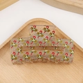 Transparent Christmas hair claw clip with candy cane and bow pattern on wooden tray - Candy Cane Bow