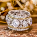 Luxurious two-tone layered ring with round main stone and pavé-set crystals in a close-up shot - US 7 / Two Colors