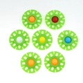 Top view of seven colorful silicone flower-shaped fidget toys on a white background - Green