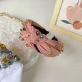 Pink fabric knotted headband featuring colorful rhinestones on a crystal bowl display - Pink