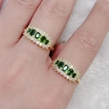 Adjustable copper ring with green zircon stones and white diamond accents on a model hand - Multi-Stone Horizontal Row Green