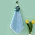 Hanging sky blue coral fleece hand towel featuring a green cartoon dinosaur design - Dinosaur-Bare / Blue