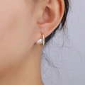 Minimalist gold geometric earrings featuring white pearls worn on a female model's ear - Arch Pearl Style (E01242G)