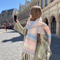 Pink and blue plaid mohair scarf with tassels worn by a model in an urban square setting - Large Mohair Braid - Striped Pink