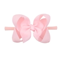 Pink elastic nylon baby headband with a large ribbed fabric bow on a clean white background - Pink