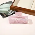 Macro view of square pearlescent hair claw clip with purple shell texture on wooden tray - PVC 10.5cm Rectangular - Iridescent Purple