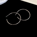 Minimalist silver-finished metal hoop earrings with a polished round surface on black background - 4cm / Silver Needle / Silver