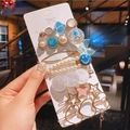Detail of assorted pearl and rhinestone hair clip set on display card with diverse styles - Heart Fish Tail 7-piece Set