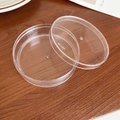 Detail of round transparent travel jewelry box with No. 123 engraving on a wood surface - Large Round Storage Box