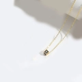 Golden necklace with square black and gold pendant featuring a minimalist letter K design - Letter K
