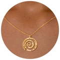 Golden spiral pendant necklace with hammered texture shown worn on neck for women - Spiral Vortex Necklace