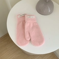 Pink plush mittens for women with Hand Made tag on a clean minimalist tabletop - Pink