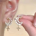 Elegant gold moon and star pearl earrings with small diamonds shown on ear and hand - Gold Crescent Moon Star Rhinestone Earrings (0993 Earrings)