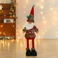 Macro detail of Santa doll with red plaid hat and festive berries for Christmas decor - Santa Claus