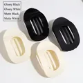 Flat lay of oval leopard hair clips in glossy and matte black and creamy white finishes - Glossy Black/White/Matte Black/White