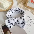 Leopard print plush headband featuring a large bow in white coral fleece material - White Leopard