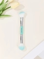 Detailed macro view of dual-ended makeup brush with teal handles and synthetic bristles - Cyan