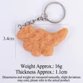 Realistic fried chicken nugget dinosaur keychain with textured crispy skin on white background - 5.9cm Dinosaur Chicken Nugget (With Keychain)