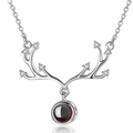 Macro detail of silver antler pendant featuring a centered circular projection stone - Eight Diamond Antler White Gold Color