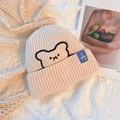 Beige knitted beanie with cartoon bear embroidery and blue brand tag for winter - One Size / Beige