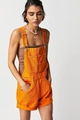 Detail of bright orange denim overalls with metal buckles and multi-pocket design - Orange