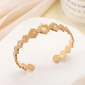 Minimalist gold-plated stainless steel open bangle with engraved sun patterns - Sun Pattern / Gold