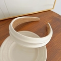 Elegant white padded headband with silk-like finish on a decorative ceramic tray - Beige Sponge Headband
