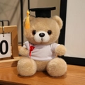 Light brown graduation teddy bear plush toy wearing white t-shirt and doctoral cap - White T-Shirt Style / Camel
