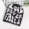 Classic black beanie with white 'Love Never Fails' jacquard text in a casual style - One Size / Black