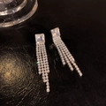 Silver bow tassel drop earrings with square cut diamonds on black leather background - Square Zirconia Four-row Pave Tassel (HSLA609 Silver)