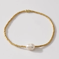 Bohemian gold metal beaded bracelet featuring a unique white baroque pearl accent - Gold Round Beads Single Baroque Pearl (MI-B24110401C)