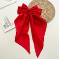 Close-up of large red satin bow hair clip with elegant long ribbons on a white background - Red