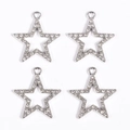 Detail of four silver star pendants with white rhinestones and hollow design - Silver Star
