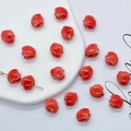 Set of 18 red shell-shaped ceramic beads for DIY jewelry making on white background - 12mm / Red
