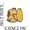Detail view of a cute capybara embroidery patch with dimensions of 5.3cm or 2.1 inches - Holding Baguette