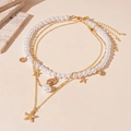 Juego de collares dorados de varias capas con conchas, perlas y colgante de estrella de mar - Dorado
