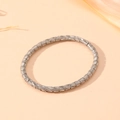 Detail view of silver twisted cable bracelet with elegant woven texture on a beige background - Steel Segmented Texture Style (S508)