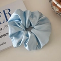 Oversized ice blue satin scrunchie with elegant pleated fabric and silky texture - Glossy Blue
