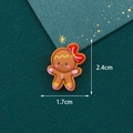 Brown resin gingerbread man DIY craft accessory with red bow and size 2.4cm x 1.7cm - Gingerbread Man