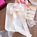 Elegant oversized cream white satin bow hair clip with organza streamers on display card - Beige