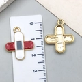 Red and white enamel medical cross charm pendant with golden finish and ruler measurement - Red Band-Aid
