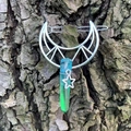 Silver hollow moon hair clip with rainbow crystal pillar and star pendant on bark - Blue Green Crystal
