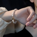 Elegant freshwater pearl bracelet with geometric gold clasp worn on a woman's wrist - Pearl Magnetic Clasp Safety Chain Style (2)