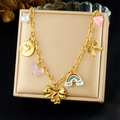 Detailed view of gold necklace with pearl, heart, butterfly, and rainbow charms in a box - Pearl Heart Rainbow Cloud Style (N3770)